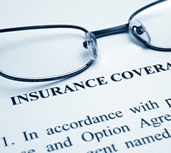 Black-framed glasses at the top of an insurance form