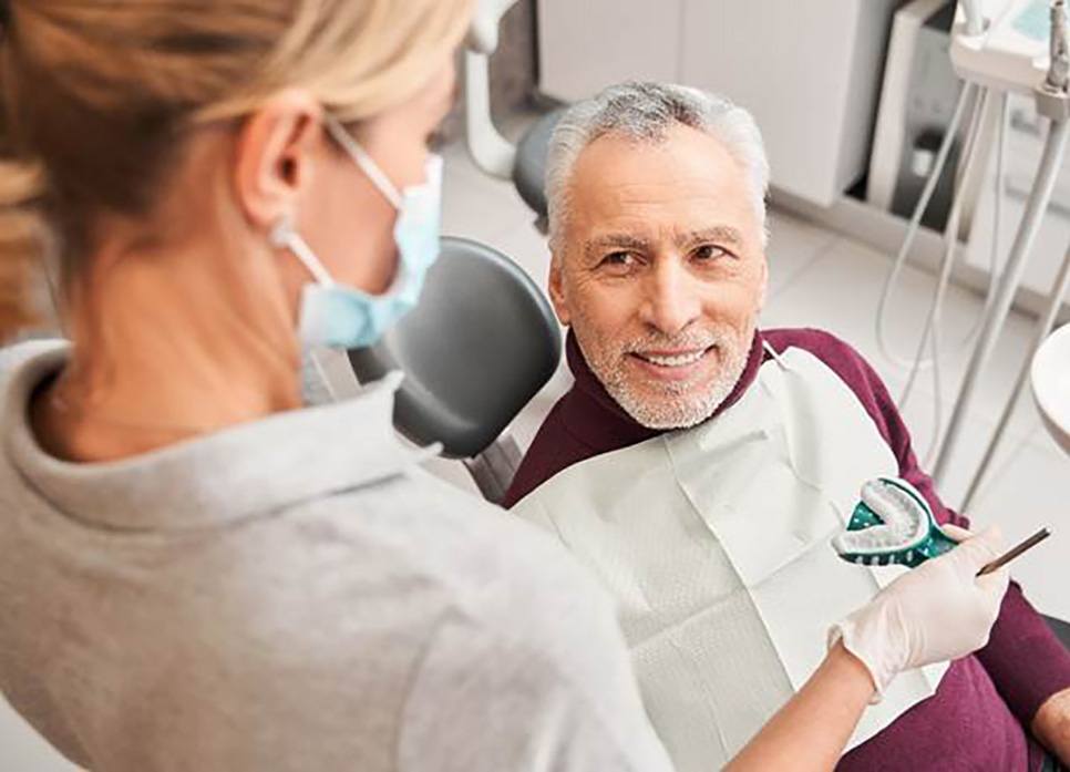 A smiling man getting dentures in Spring Hill