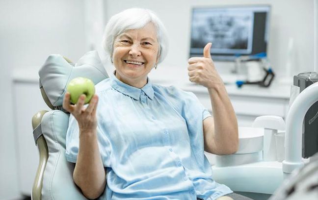 A woman enjoying her dentures in Spring Hill