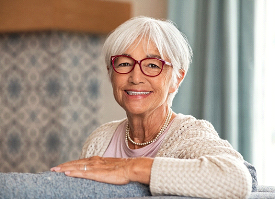 Senior woman with glasses and implant dentures in Spring Hill, TN