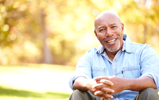 Man with implant dentures in Spring Hill, TN sitting outside