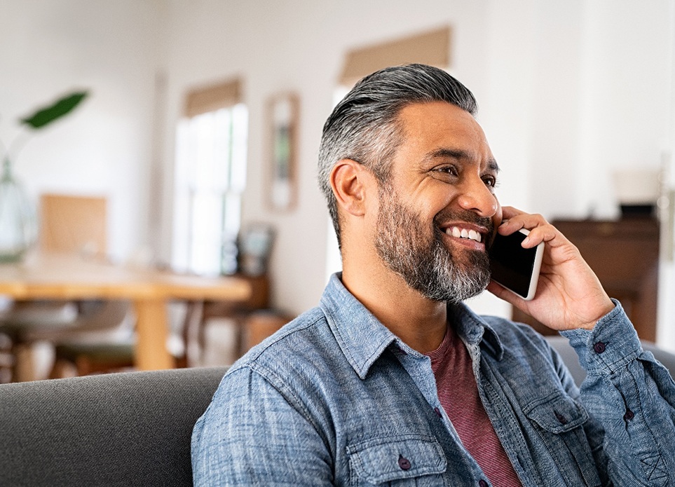 Man on the phone after seeing Lincoln Financial Group dentist in Spring Hill