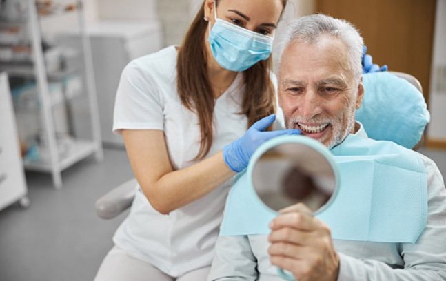 a patient checking their smile after getting dental implants