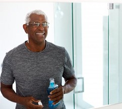 a man smiling after rinsing his teeth with mouthwash