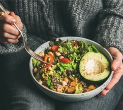 a person enjoying a bowl of healthy food