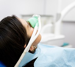 Patient breathing in nitrous oxide in treatment chair