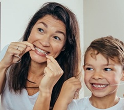 Woman smiling while eating healthy meal at home