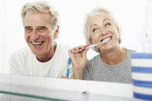 senior couple cleaning teeth 