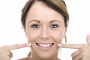 woman pointing at teeth