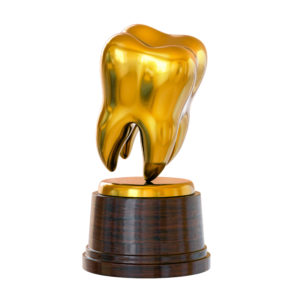 A trophy shaped like a gold dental crown 