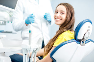 Smiling woman in dental chair 