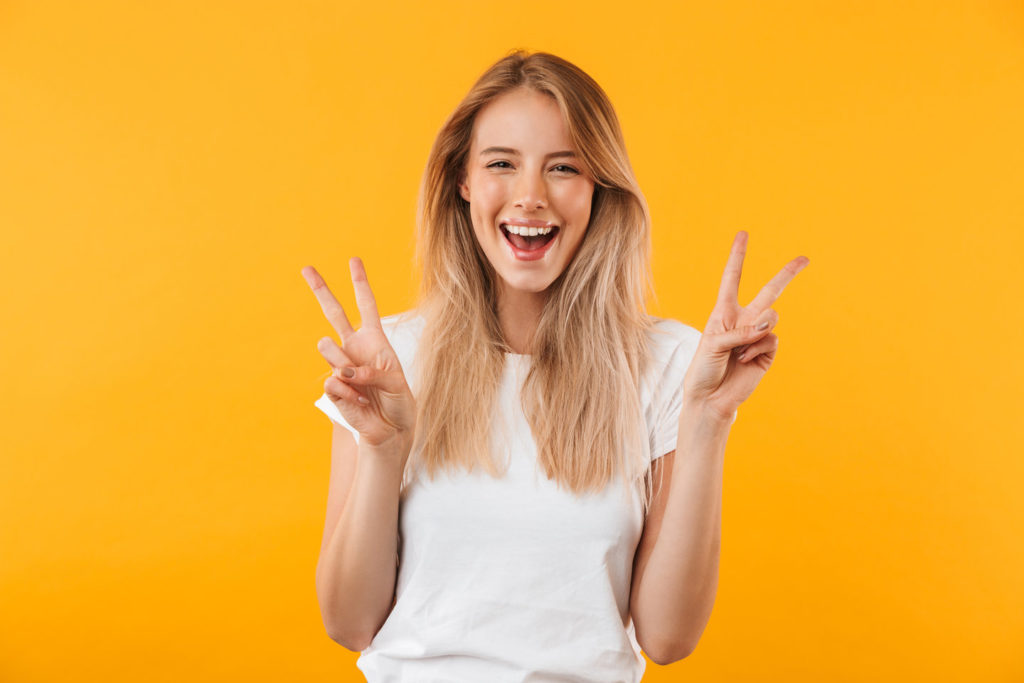 Woman shows a peace sign to her dentist in Spring Hill.