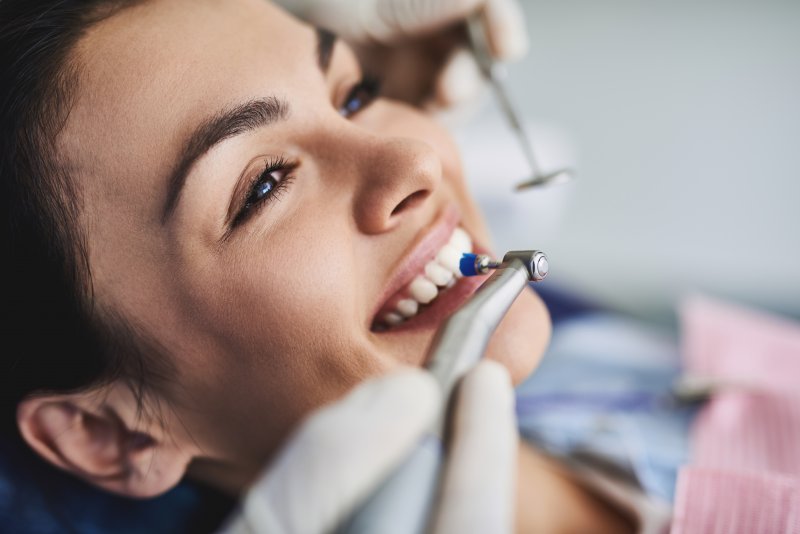 woman getting teeth cleaning in Spring Hill