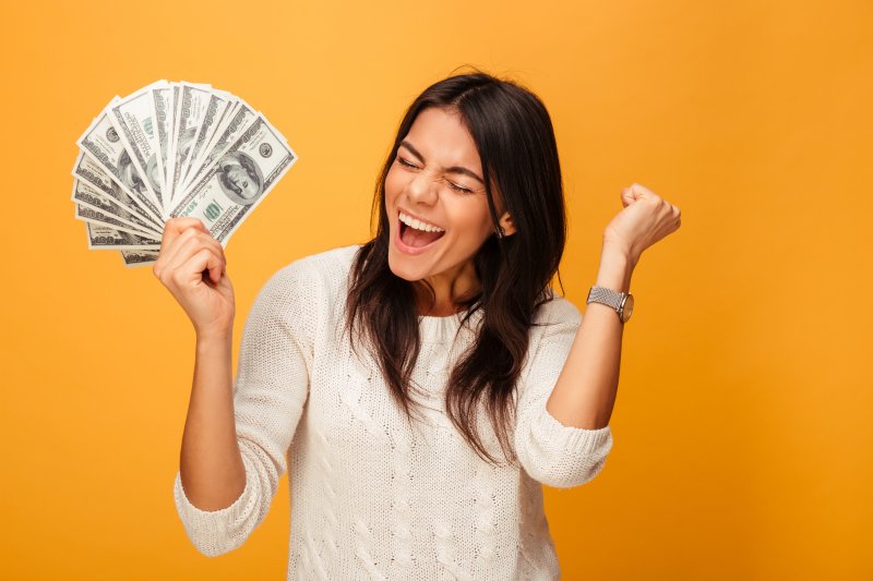 woman excited while holding money 
