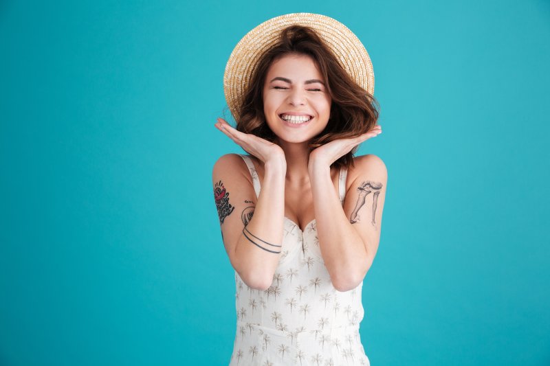 Cheerful woman wearing a straw hat